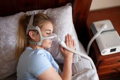 adult woman sleeping with cpap 