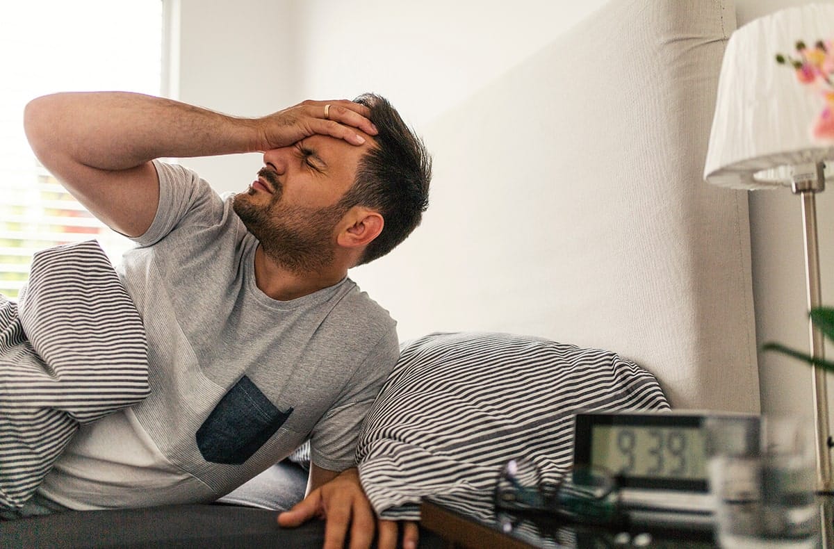 man with morning headache, a symptom of sleep apnea