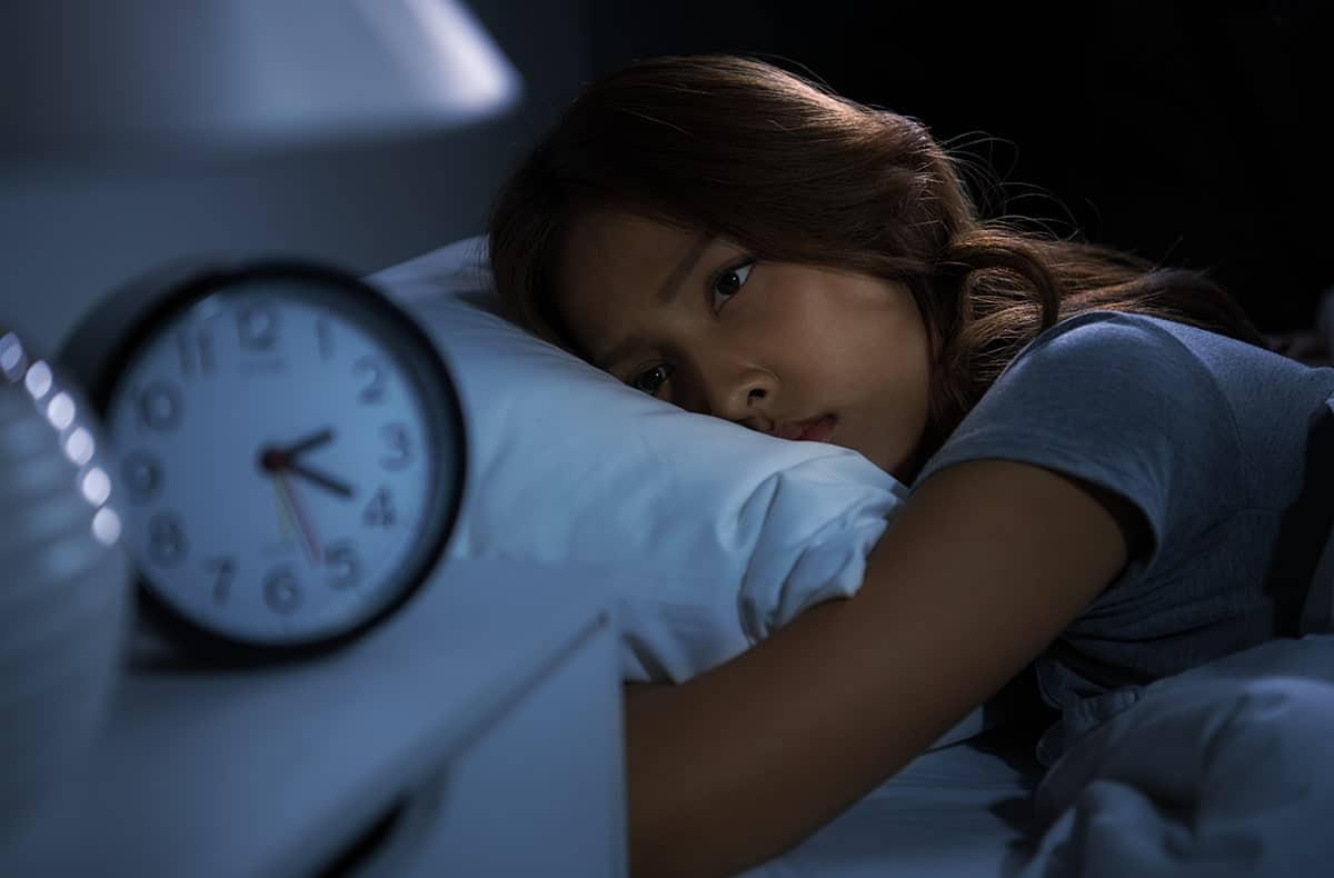 a child wide awake at night, a symptom of sleep apnea